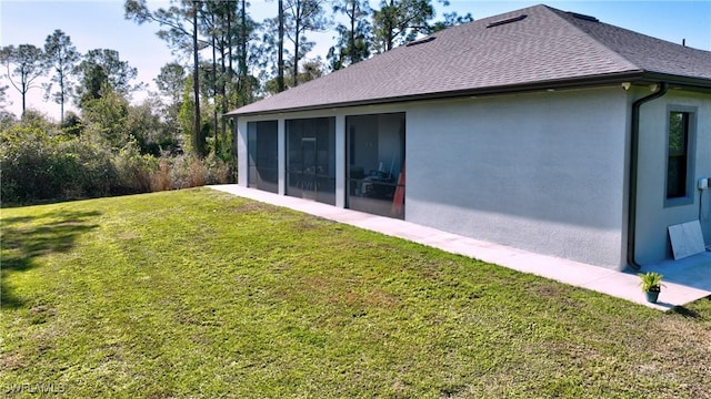 back of property with a yard and a sunroom