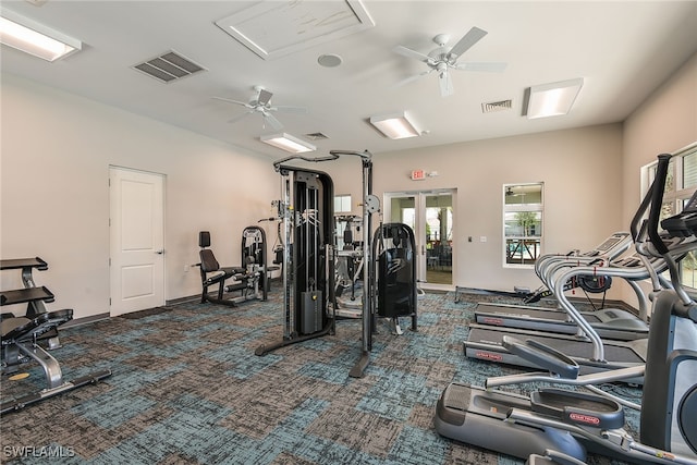 gym featuring ceiling fan and dark carpet