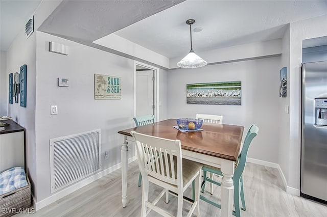 dining area with light wood-type flooring