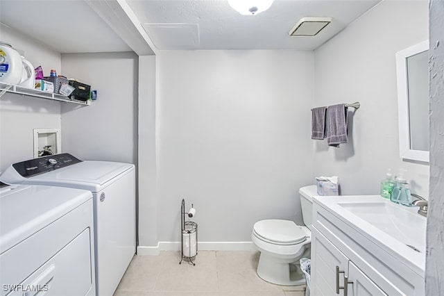 washroom featuring washer and dryer, light tile patterned flooring, and sink