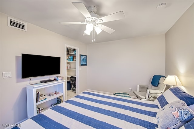 bedroom with ceiling fan and a closet