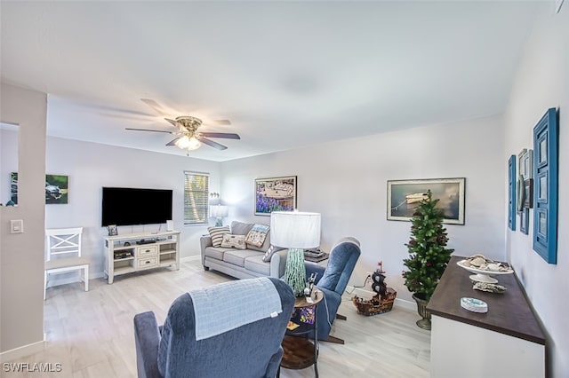 living room with light wood-type flooring and ceiling fan