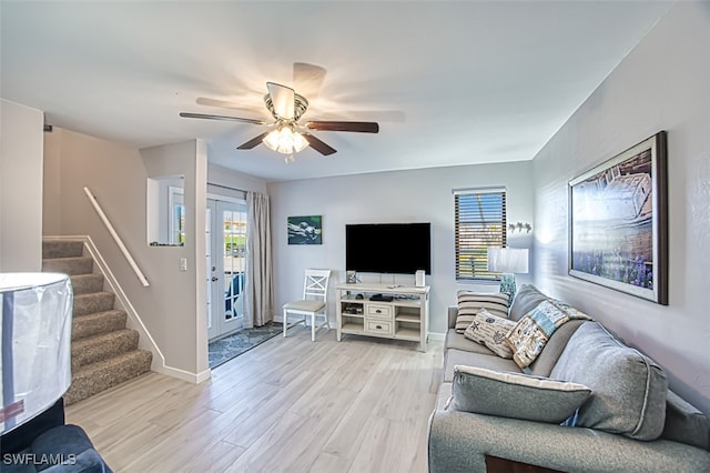 living room featuring light wood-type flooring and ceiling fan