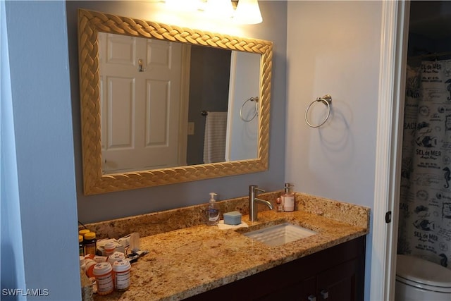 bathroom featuring vanity and toilet