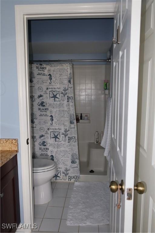 bathroom featuring tile patterned flooring, a shower with curtain, vanity, and toilet