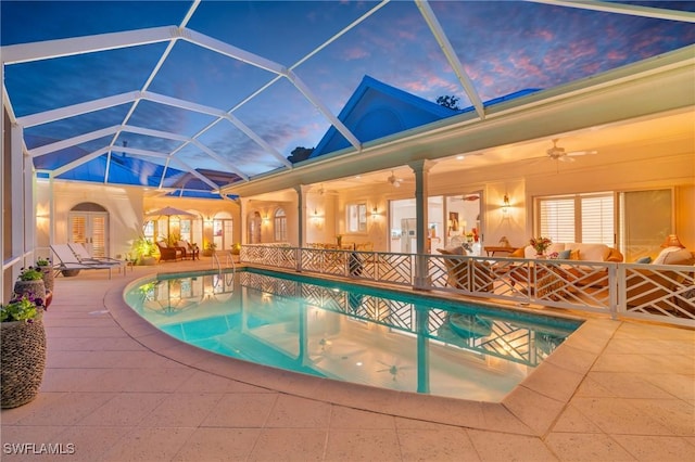 pool at dusk with ceiling fan, a lanai, french doors, and a patio