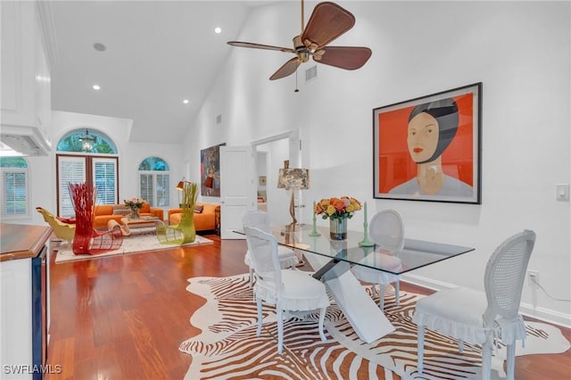 dining space featuring high vaulted ceiling, ceiling fan, and hardwood / wood-style floors