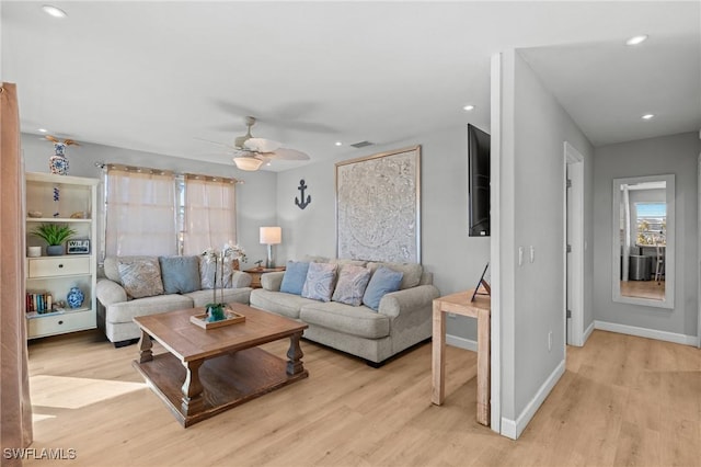 living room with light wood-type flooring and ceiling fan