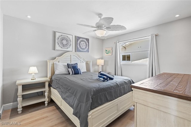 bedroom with ceiling fan and light hardwood / wood-style flooring