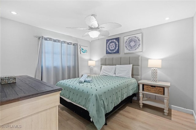 bedroom featuring recessed lighting, wood finished floors, baseboards, and ceiling fan