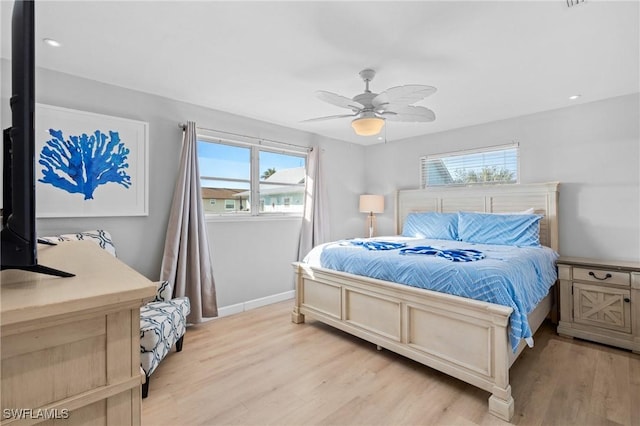 bedroom with ceiling fan and light wood-type flooring