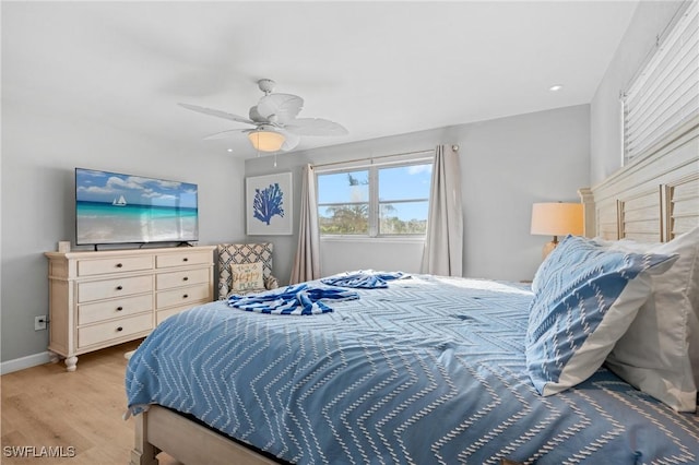 bedroom with ceiling fan and light hardwood / wood-style floors