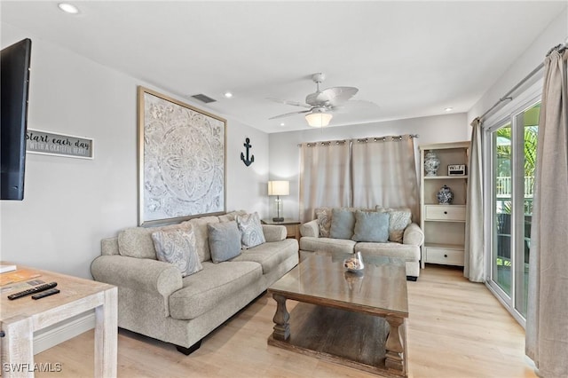 living room with ceiling fan and light wood-type flooring