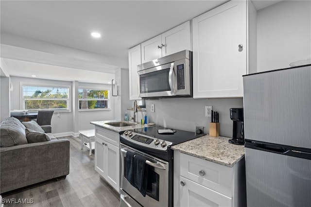 kitchen with sink, white cabinetry, and stainless steel appliances