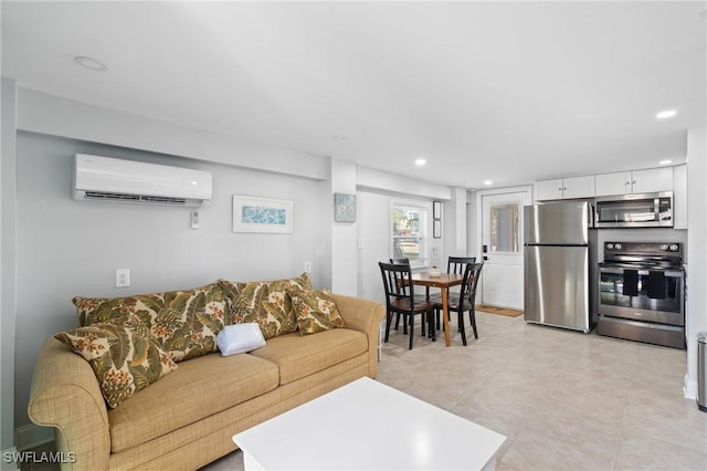 living area with recessed lighting and a wall mounted AC