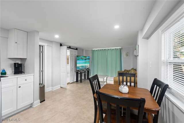 dining room with recessed lighting and a barn door