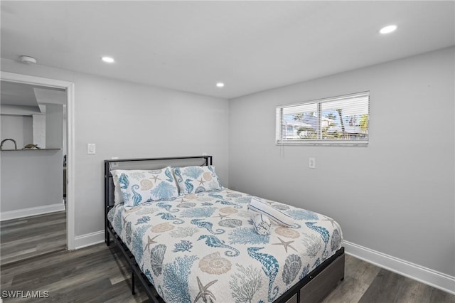 bedroom with recessed lighting, wood finished floors, and baseboards