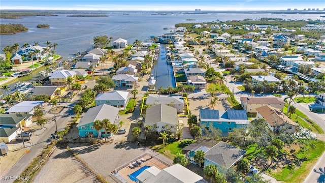 drone / aerial view featuring a residential view and a water view