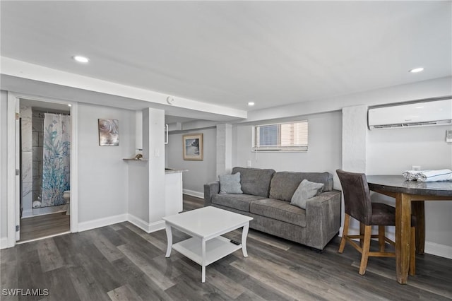 living room featuring a wall mounted air conditioner and dark hardwood / wood-style floors