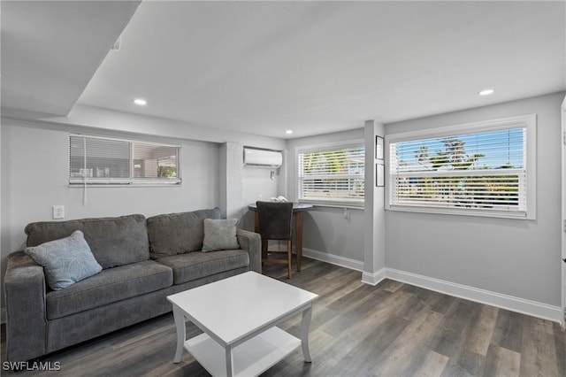 living room with recessed lighting, an AC wall unit, dark wood-type flooring, and baseboards