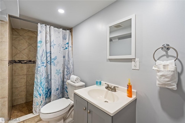 bathroom featuring tile patterned flooring, a shower with curtain, vanity, and toilet