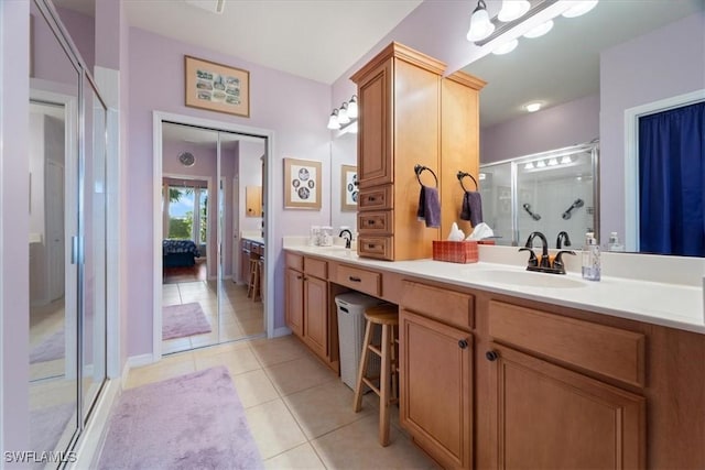 bathroom featuring vanity, tile patterned flooring, and walk in shower