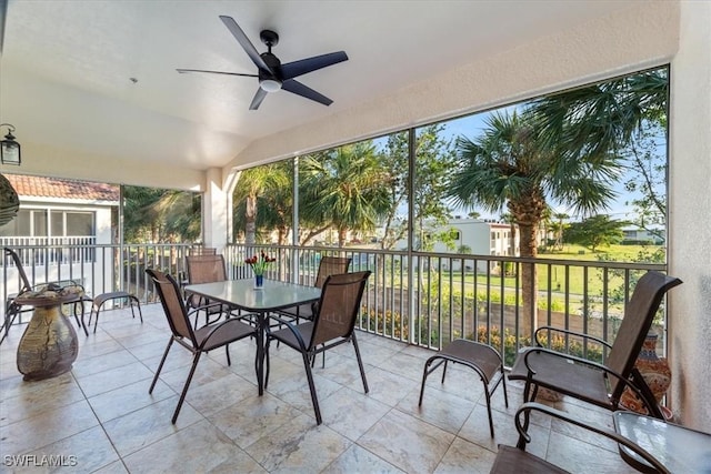 sunroom / solarium with lofted ceiling and ceiling fan