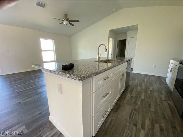 kitchen featuring sink, dishwasher, stone counters, a kitchen island with sink, and white cabinets