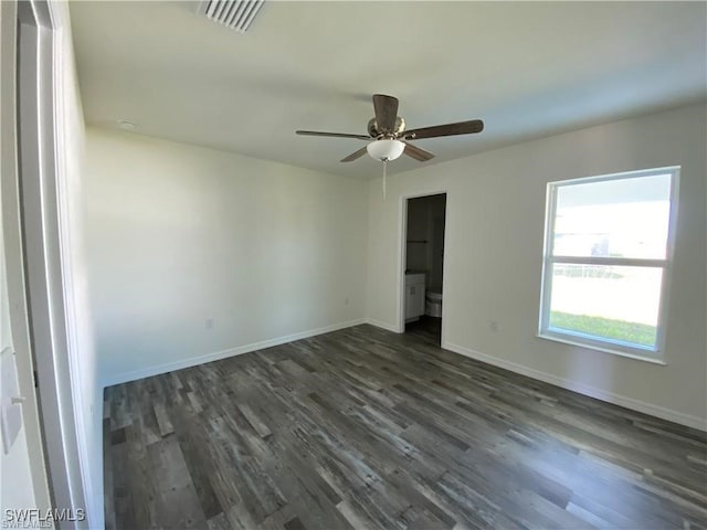 empty room featuring ceiling fan and dark hardwood / wood-style flooring