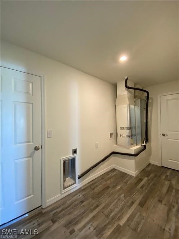 clothes washing area featuring dark hardwood / wood-style floors and hookup for an electric dryer