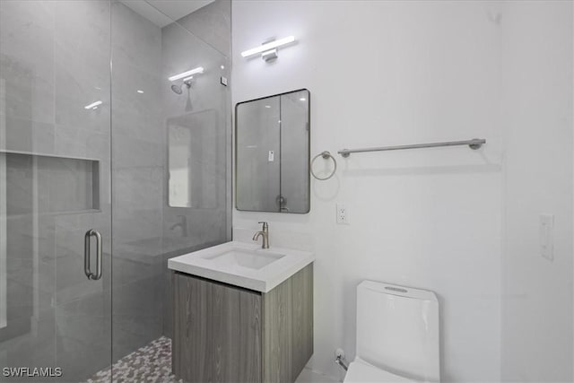 bathroom featuring vanity, an enclosed shower, and toilet