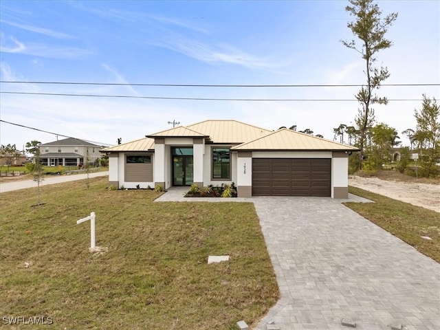 view of front facade with a garage and a front lawn