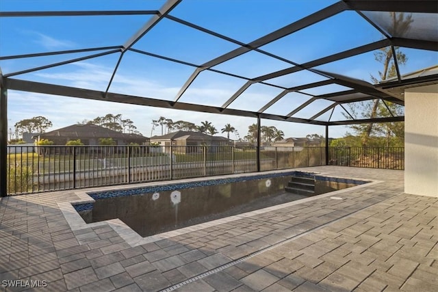 view of pool featuring a patio and glass enclosure