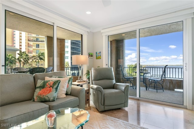 interior space with plenty of natural light, light tile patterned floors, ornamental molding, and a wall of windows