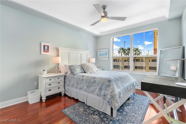 bedroom with ceiling fan, dark hardwood / wood-style floors, and ornamental molding