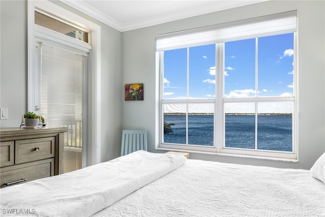 bedroom with a water view and ornamental molding