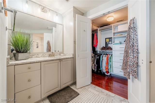 bathroom with crown molding and vanity