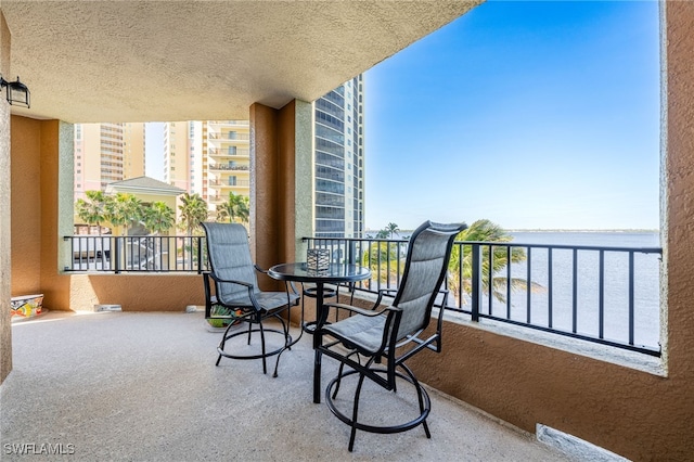 balcony featuring a water view