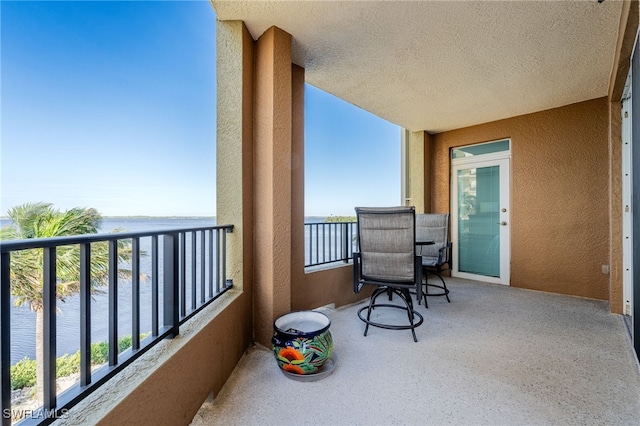 balcony featuring a water view