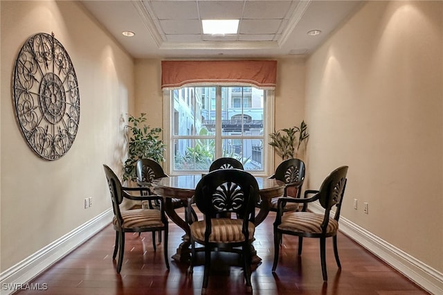 dining area featuring dark hardwood / wood-style flooring and a tray ceiling