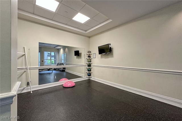 exercise area featuring a paneled ceiling