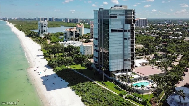 birds eye view of property with a water view and a view of the beach