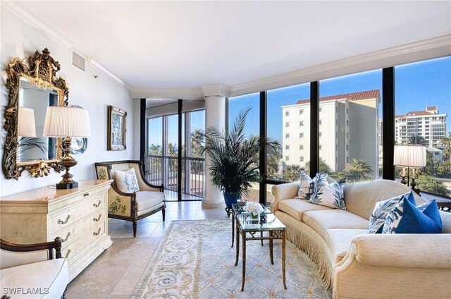 living room featuring ornamental molding, a healthy amount of sunlight, and expansive windows