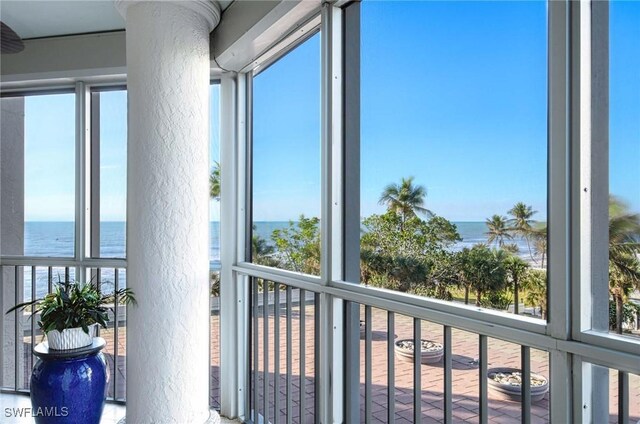 sunroom with a healthy amount of sunlight and a water view