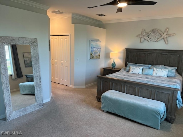 carpeted bedroom featuring a closet, ceiling fan, and ornamental molding