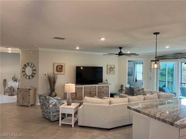 tiled living room featuring ceiling fan and ornamental molding