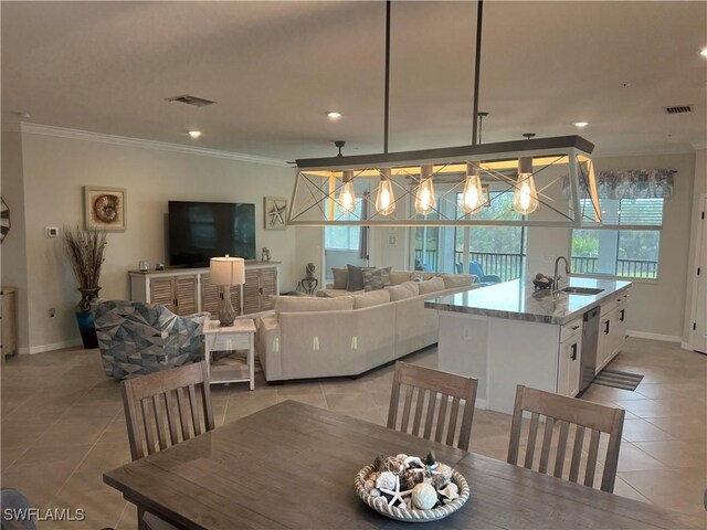 tiled dining space with sink and ornamental molding