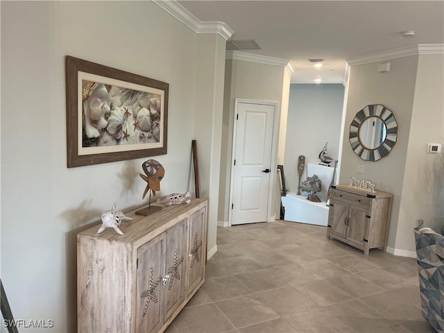 hallway with ornamental molding and light tile patterned floors