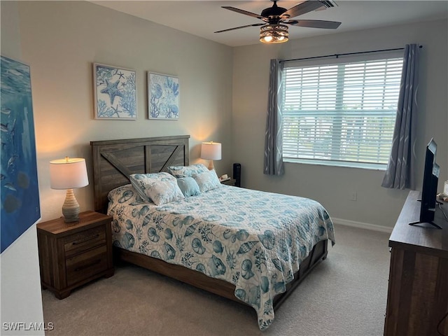 bedroom featuring light colored carpet and ceiling fan