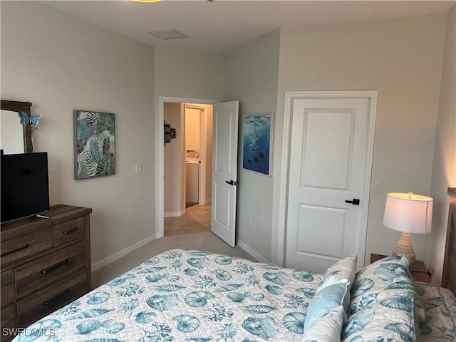 carpeted bedroom featuring washer / clothes dryer